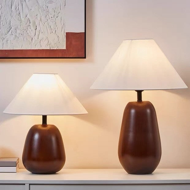 Two sizes shown for Japanese-inspired rounded solid wood table lamps with cream fabric shades