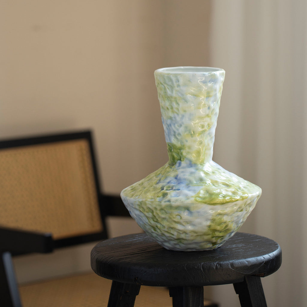 Jingdezhen blue-green textured ceramic vase displayed on dark stool