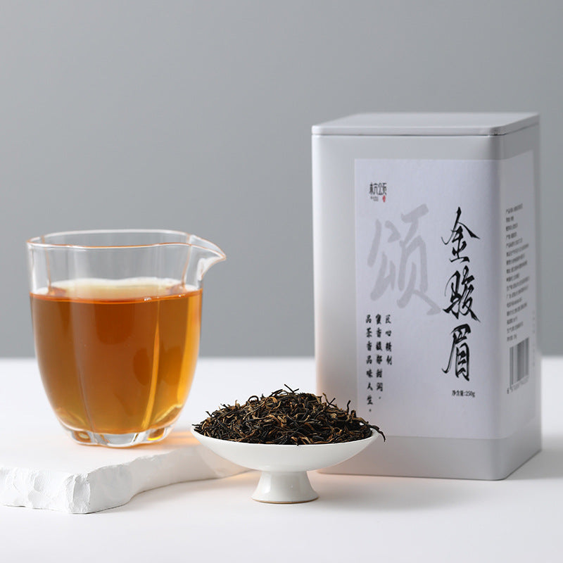 Golden amber Jin Jun Mei tea liquor in glass cup