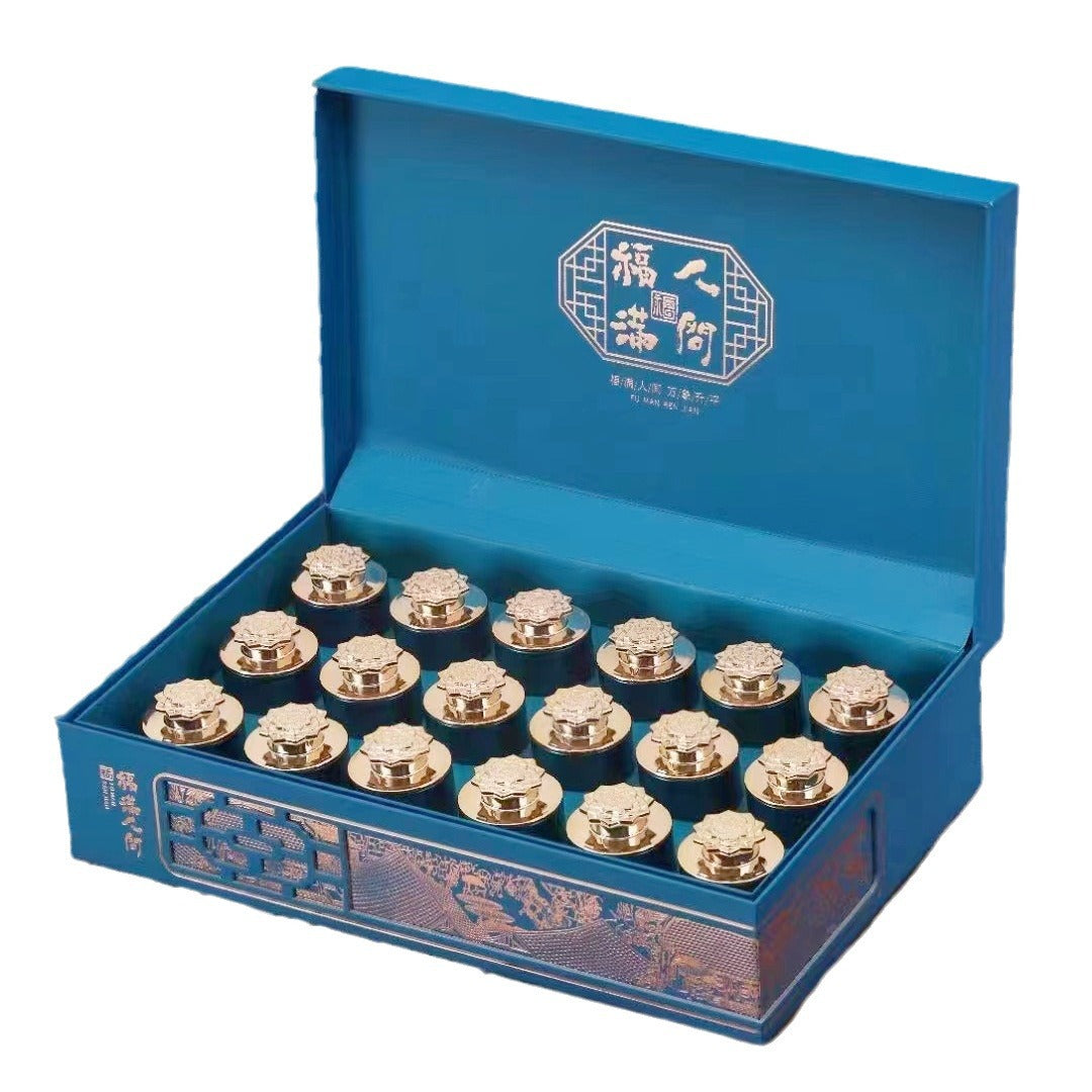 Open blue gift box with individual Zheng Shan Xiao Zhong tea tins