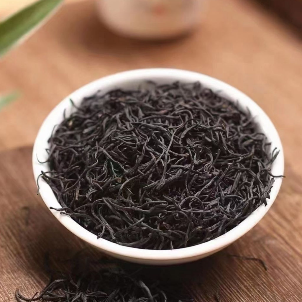 Close-up of dark twisted Zheng Shan Xiao Zhong black tea leaves