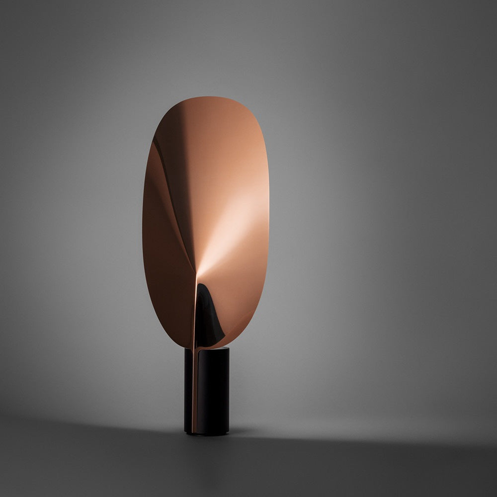Sculptural leaf table lamp in copper finish with dramatic reflected light