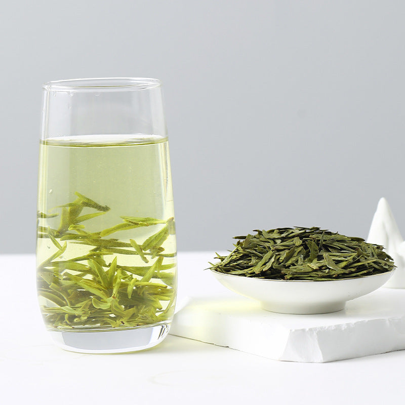 Pale green Longjing tea liquor and flat leaves