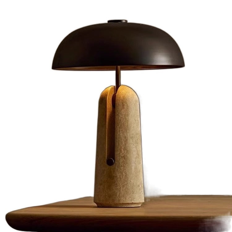 Black dome lamp with split travertine stone base and pull-switch detail