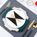 Mist blue and gold modern table setting with irregular square plate, green napkin and black-handle gold flatware