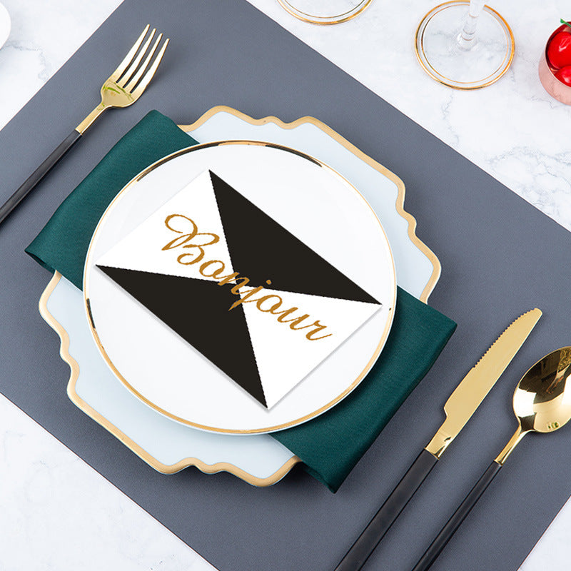 Mist blue and gold modern table setting with irregular square plate, green napkin and black-handle gold flatware