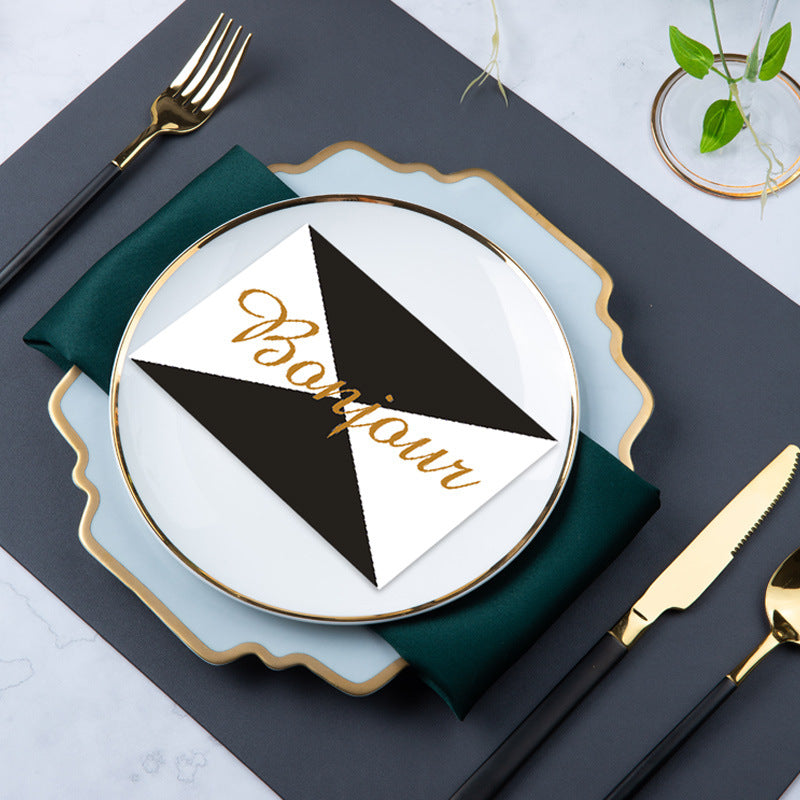 Modern mist blue and gold place setting with layered plates, grey placemat and green napkin