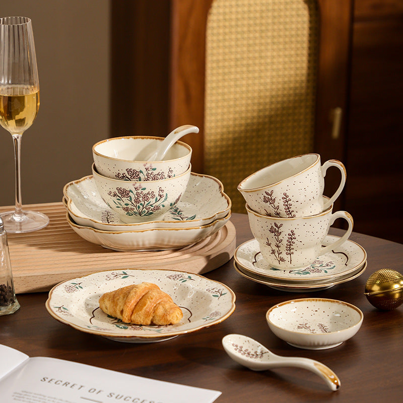 Mo Ran Hua Shi floral ceramic bowls cups saucers plates and spoons styled on a dark wood table