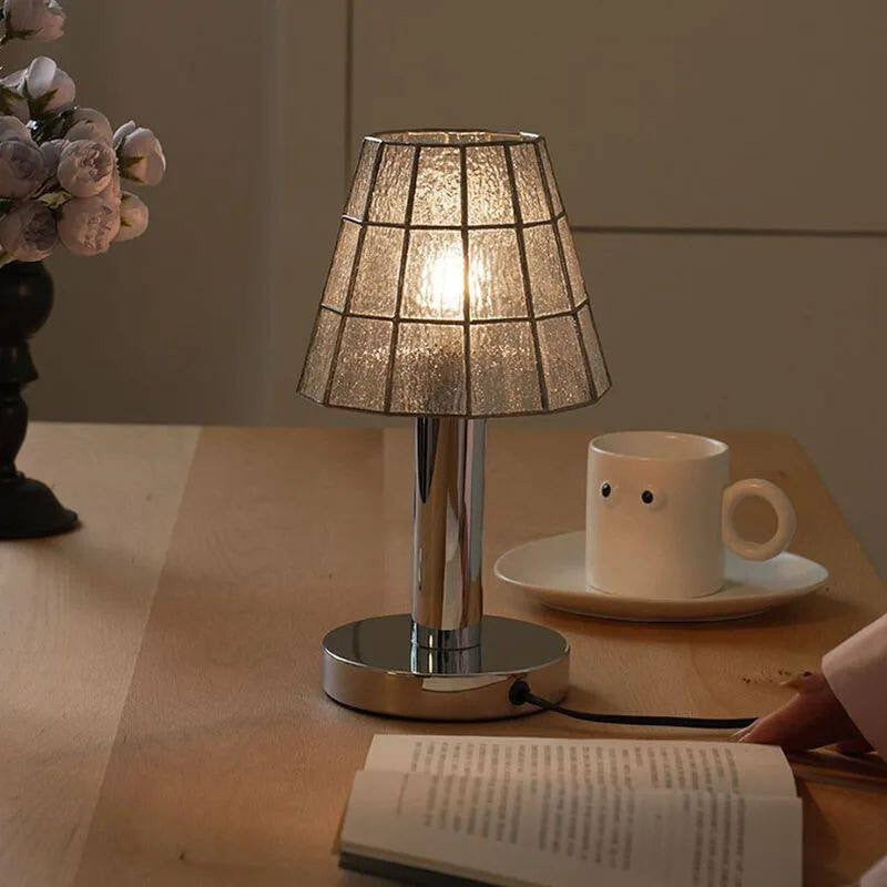 Modern clear stained glass table lamp with chrome base and warm light