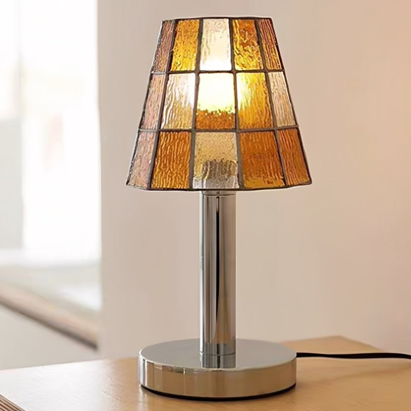 Modern orange stained glass table lamp with chrome metal base and geometric mosaic shade