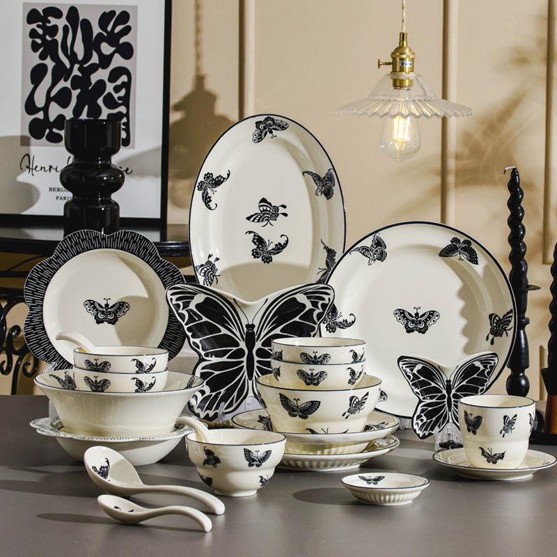 Monochrome butterfly French vintage ceramic dinnerware set with ivory plates bowls cups spoons and butterfly-shaped serving dishes