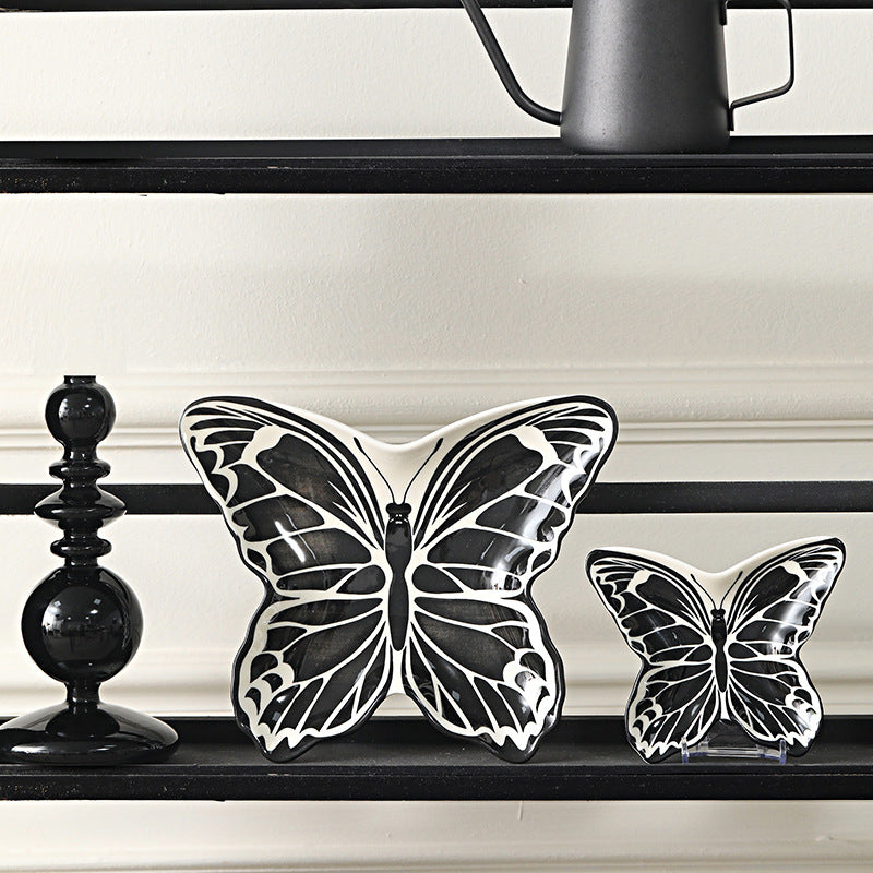 Black and ivory butterfly-shaped ceramic serving plates in large and small sizes
