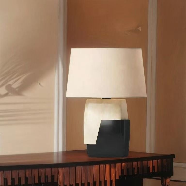 Postmodern black and ivory sculptural table lamp on a wood console