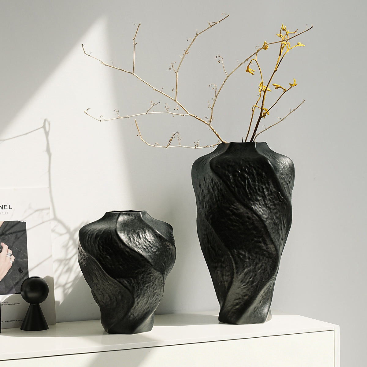 Black and white mountain spiral ceramic vases styled with branches