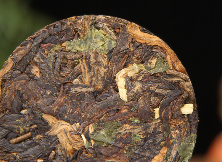 Unwrapped Yunnan black tea mini cake with nuo mi xiang aromatic leaf