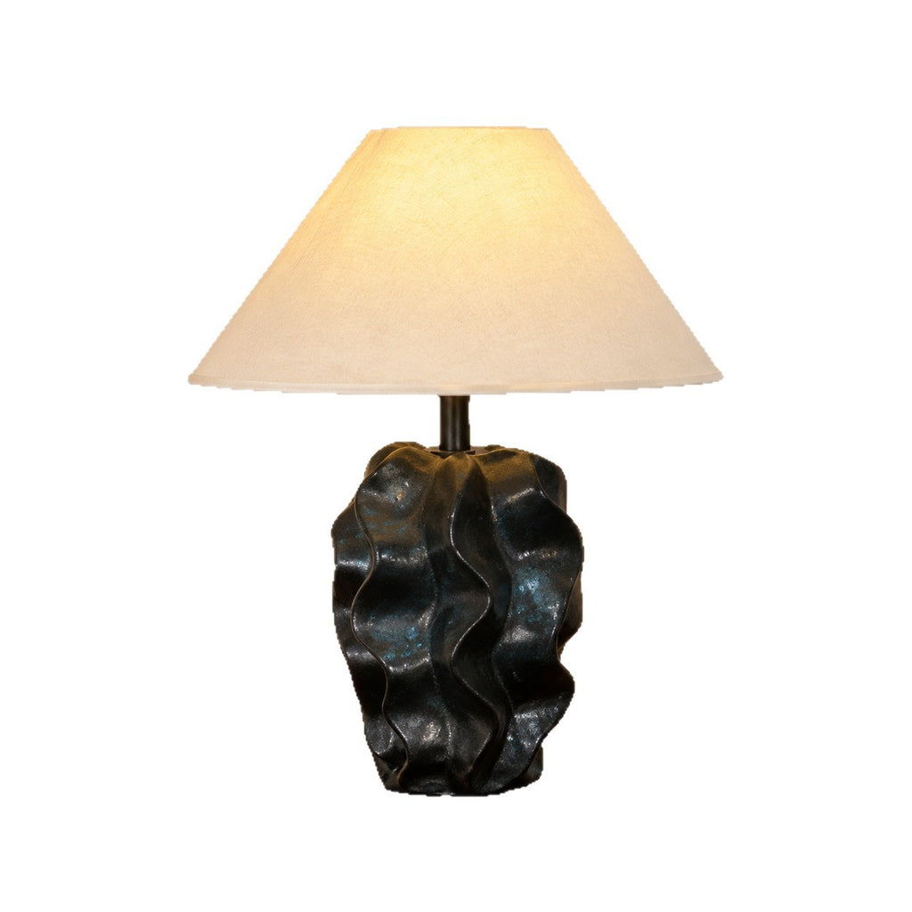 Black rock-form sculptural ceramic table lamp isolated on white background