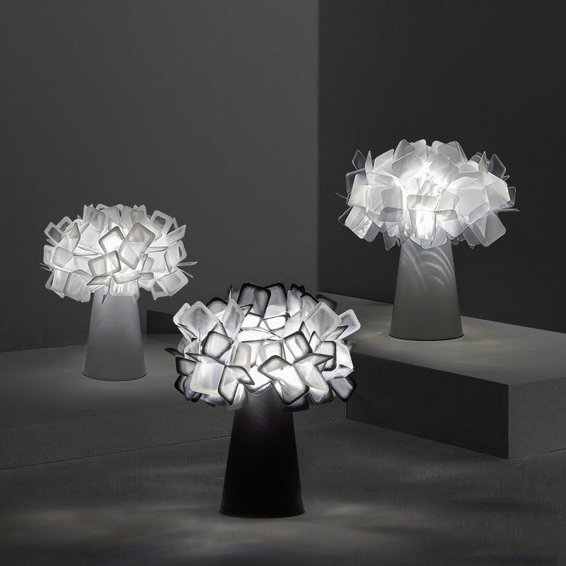 White and black petal flower table lamps arranged in a sculptural display