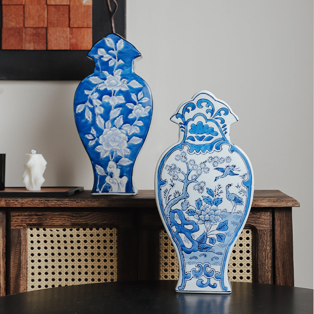 Two Phoenix Tail flat ceramic vases styled together on a wood cabinet