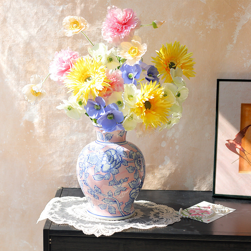 Blush pink and blue floral ceramic vase styled with flowers