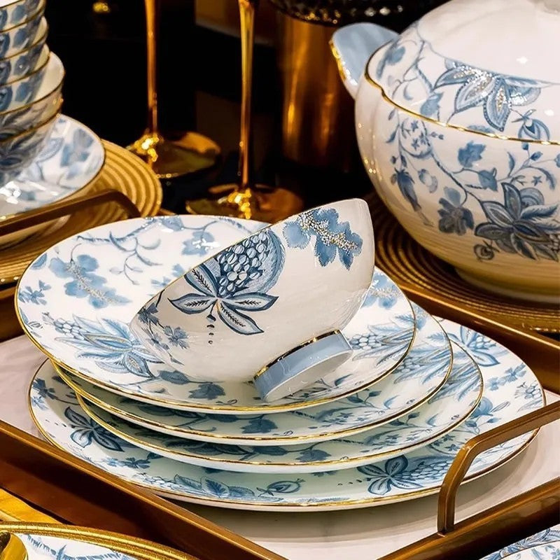 Pomegranate Blossom blue and white bone china layered place setting with gold-tone rim and floral fruit motif