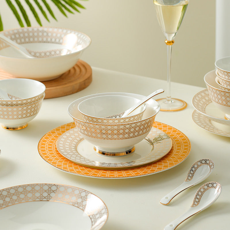 Provence lattice bone china layered place setting with footed bowl, orange dinner plate and patterned spoons
