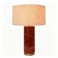 Red travertine column table lamp with broad warm fabric drum shade