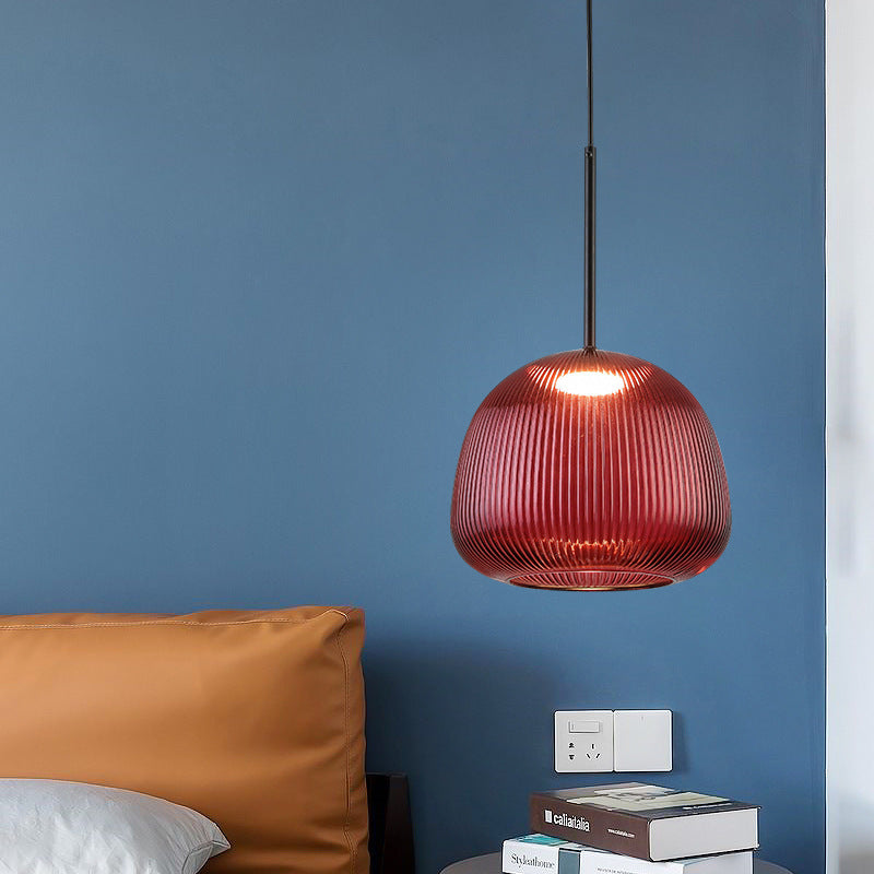 Red ribbed glass lantern light shown in a modern blue and ochre interior