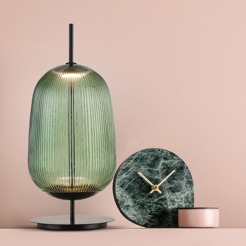 Tall green ribbed glass lantern table lamp styled with modern decor