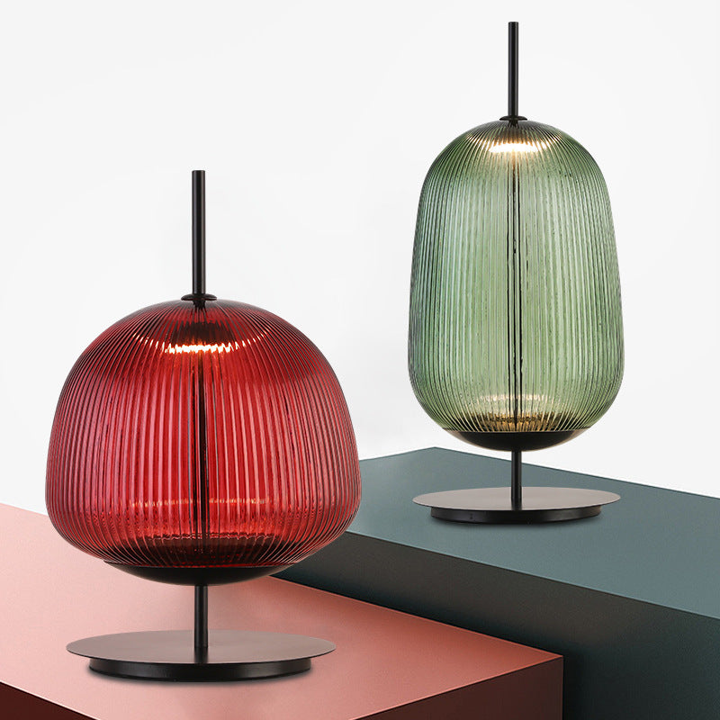 Red and green ribbed glass table lamps showing both available color silhouettes
