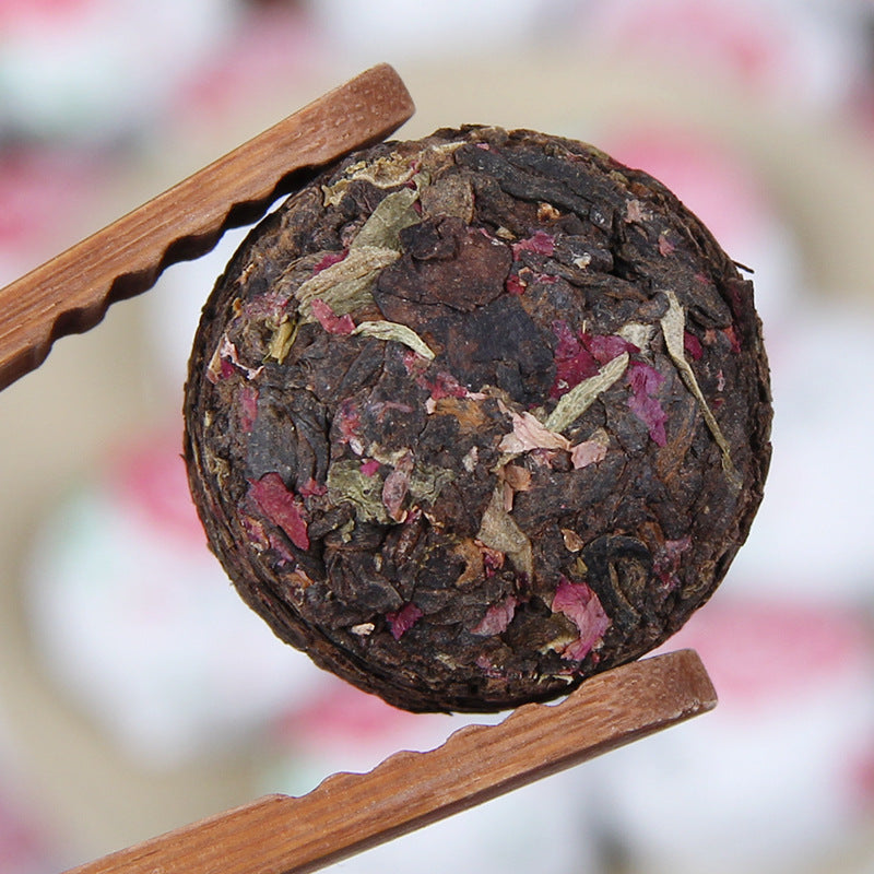 Rose Ripe Pu-erh Mini Tuocha held with tea tongs 玫瑰普洱熟茶小沱