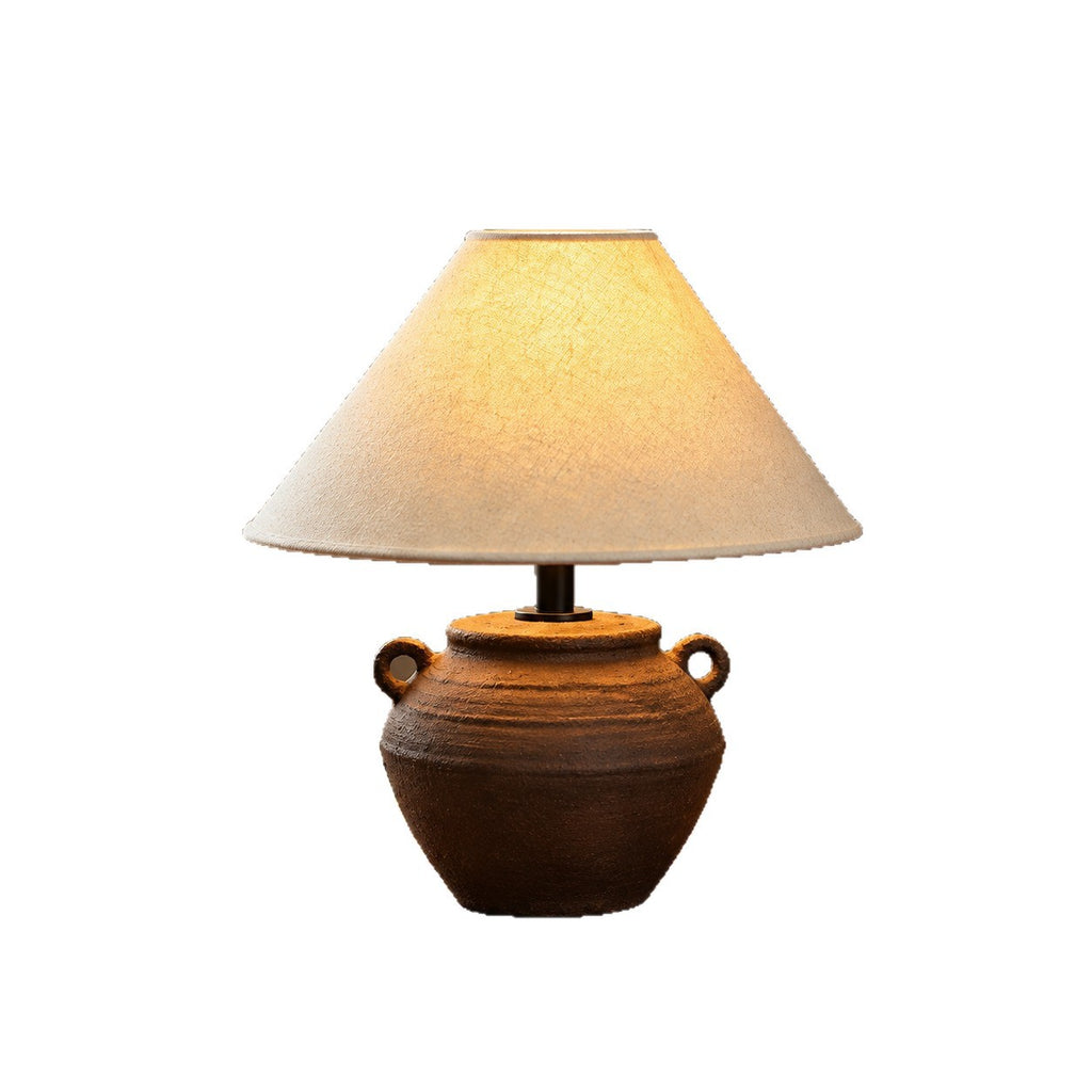 Dark brown twin-handle pottery table lamp with tapered cream shade, product view