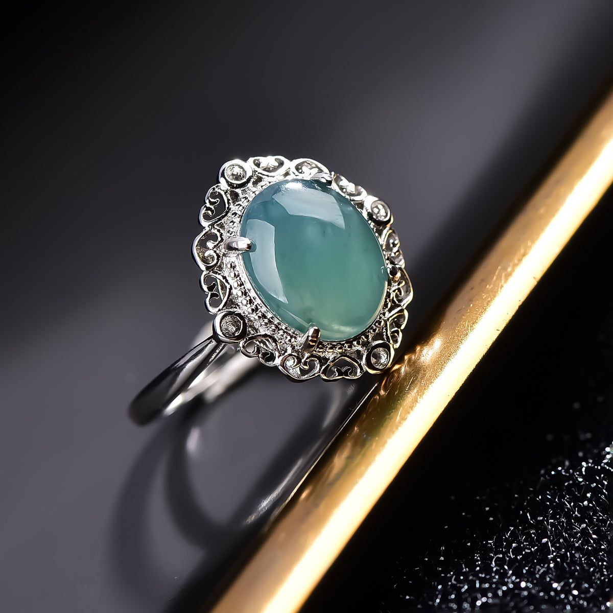 Certified natural sky blue jadeite oval cabochon ring in silver-tone halo setting