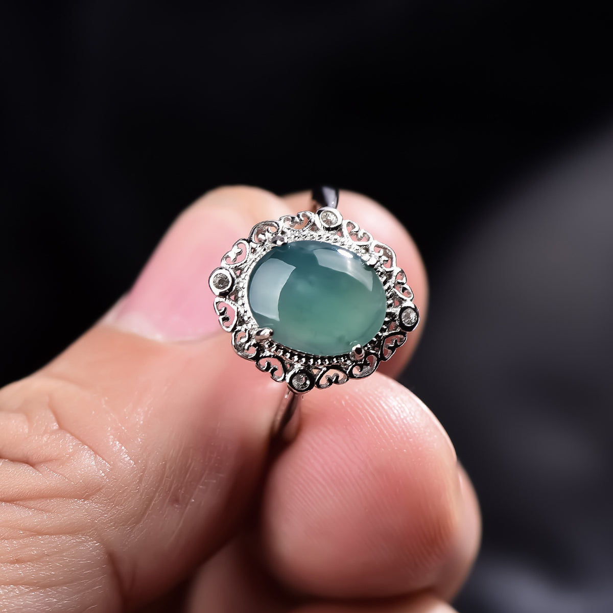 Icy sky blue jadeite cabochon ring polished oval gemstone close-up