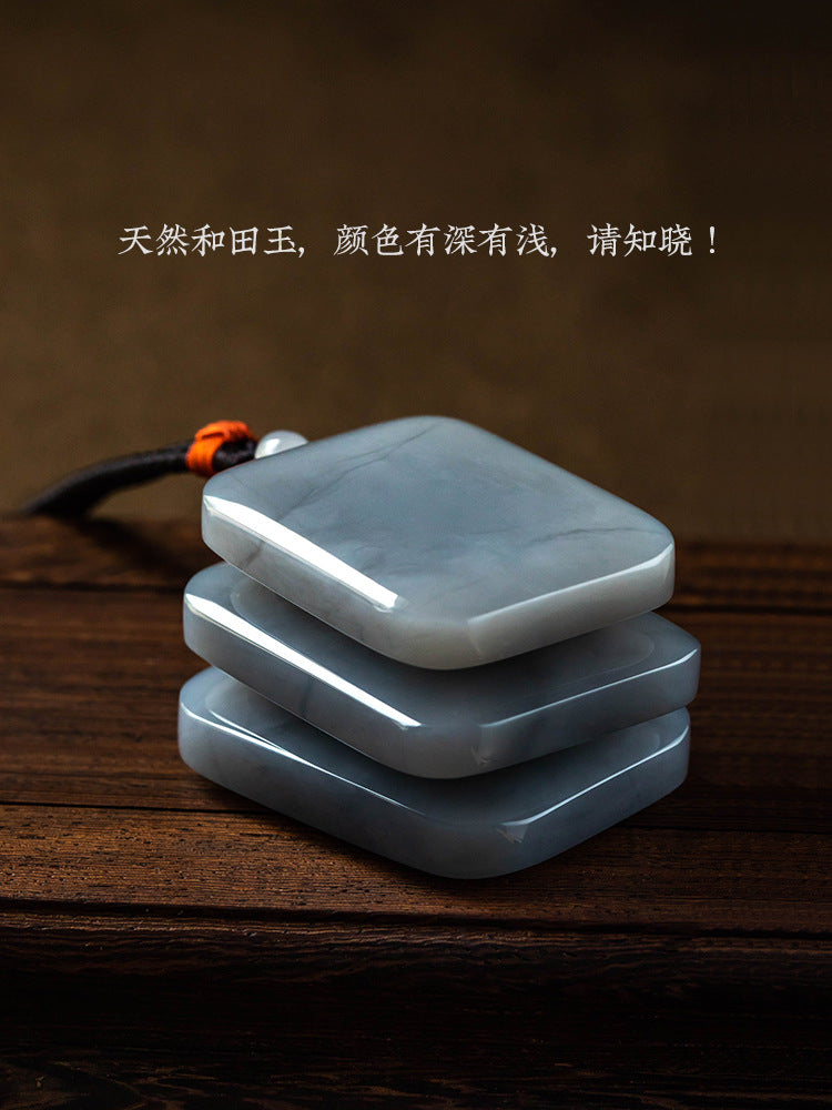 Smoky purple Hetian jade Wu Shi Pai pendant close-up with braided cord