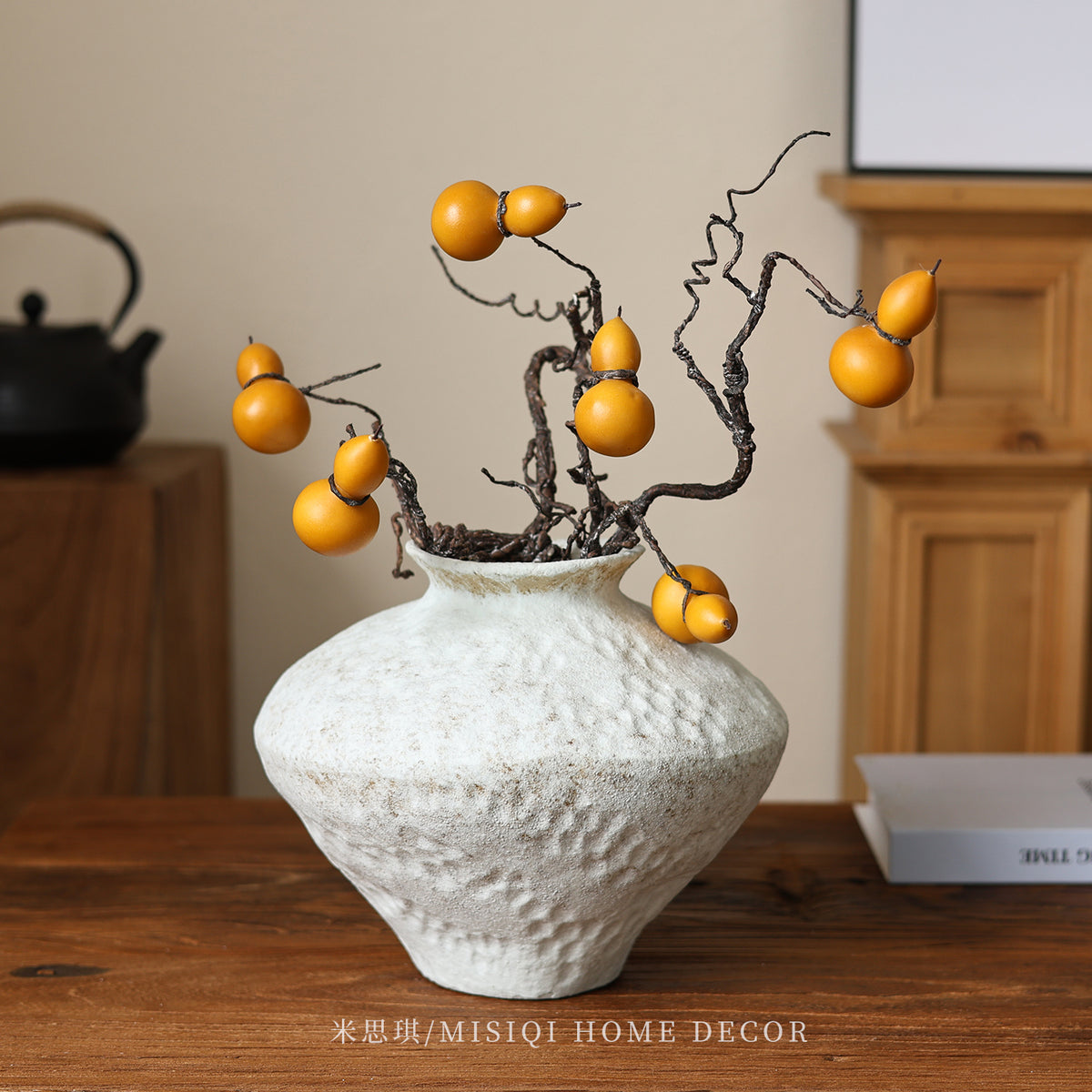 Snowfall textured ceramic vase styled with sculptural fruit branch