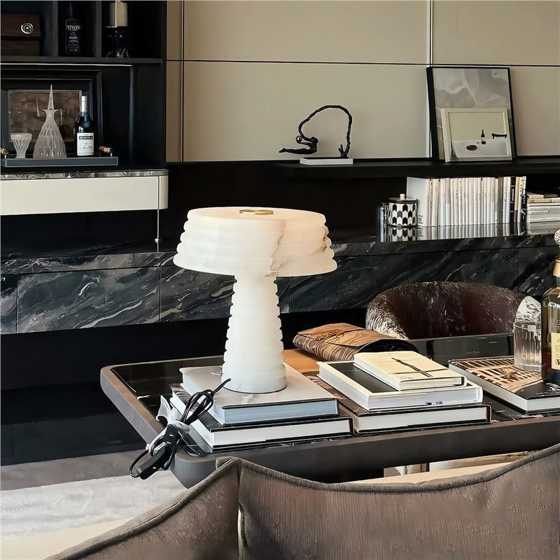 White sculptural faux alabaster table lamp on a coffee table in a luxury living room