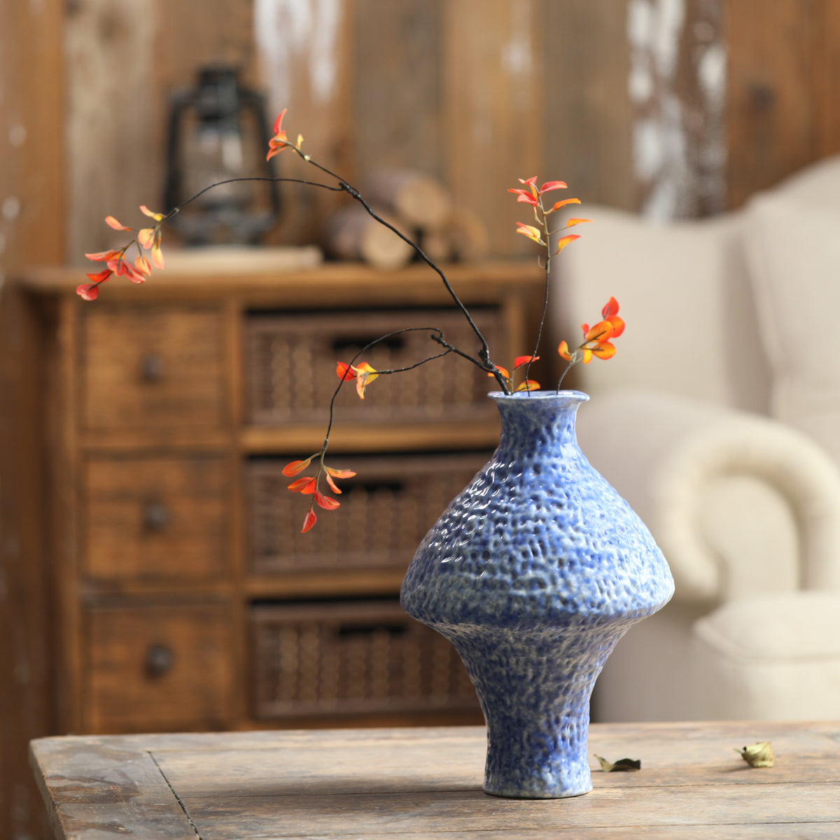 Textured blue Chinese ceramic vase with flowering branch