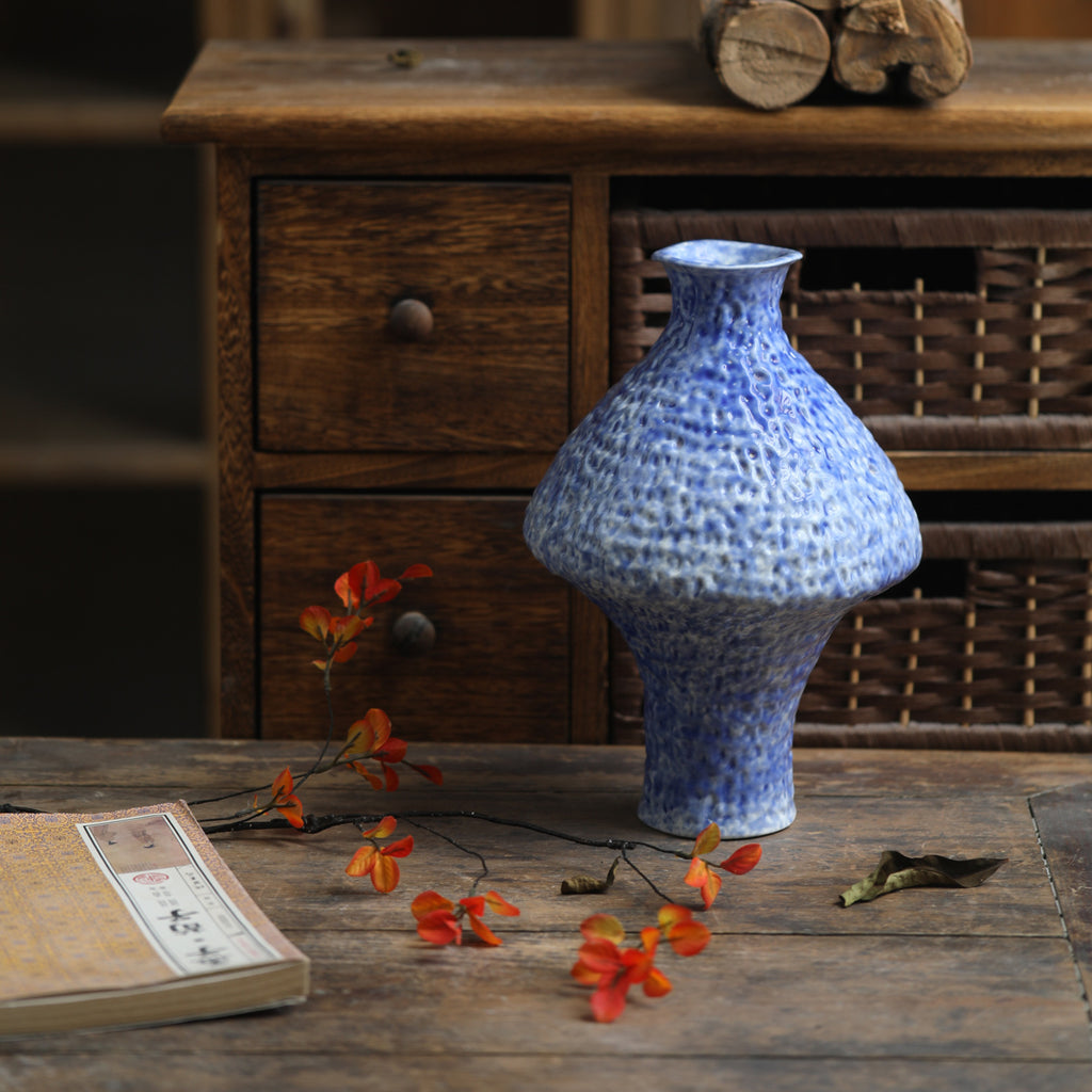 Blue Chinese ceramic vase styled on rustic wood