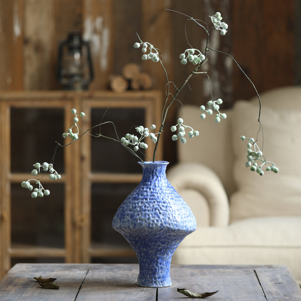 Blue textured Chinese vase with delicate flowering branches