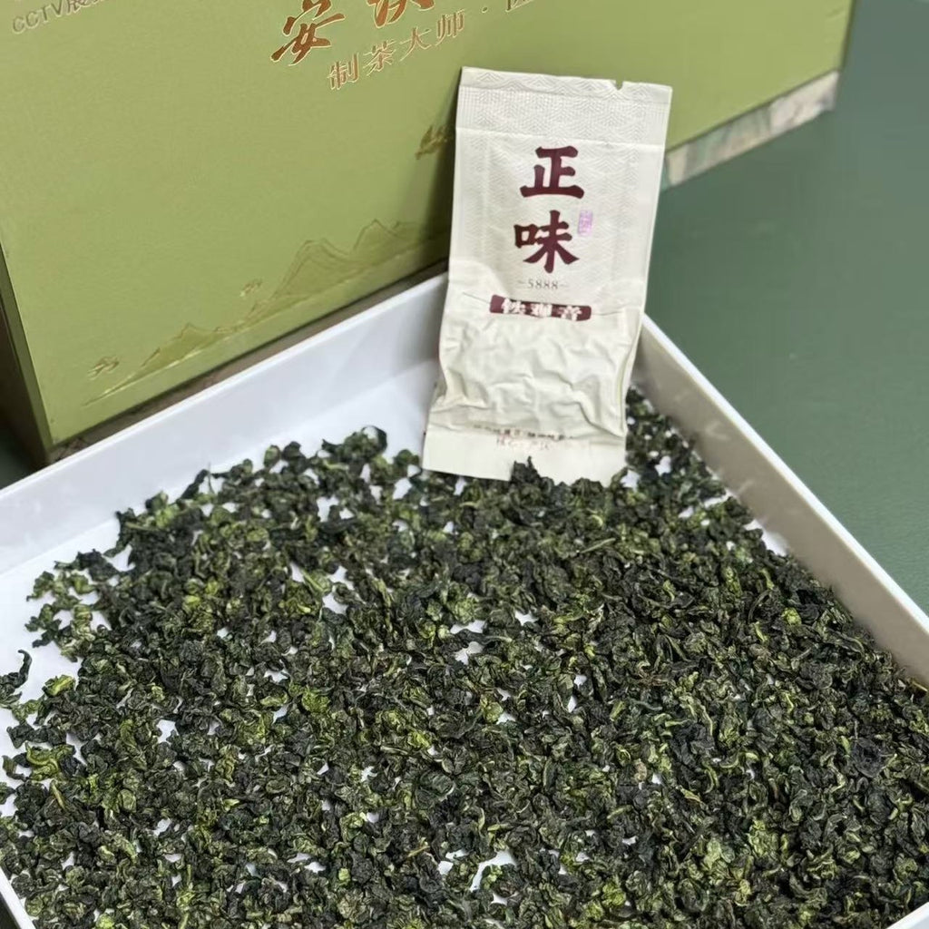Rolled Tie Guan Yin oolong leaves and green presentation box