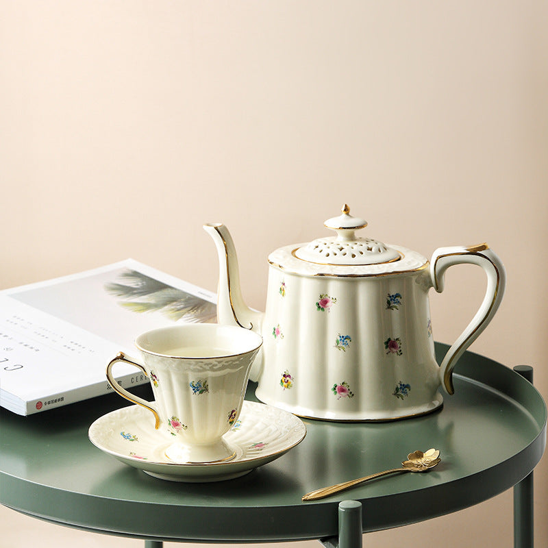 Vintage floral ceramic teapot with matching cup and saucer
