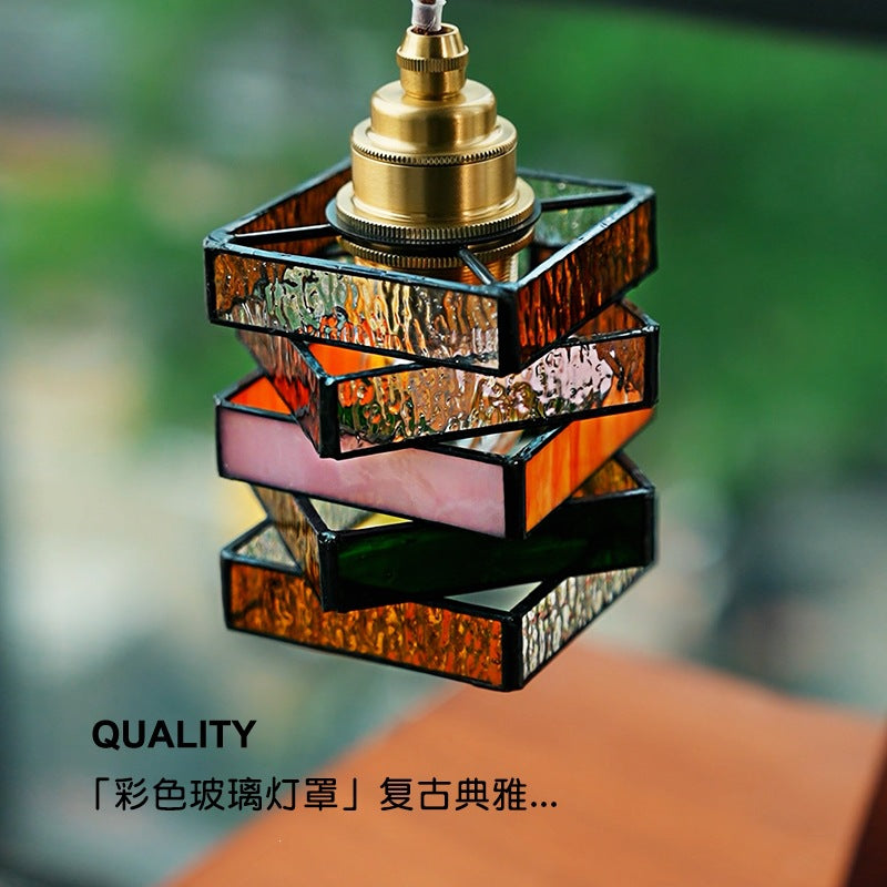 Close view of amber green clear and textured glass blocks in stacked lantern shade