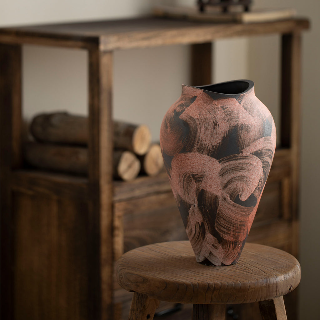 Rustic Chinese ceramic vase on wooden stool