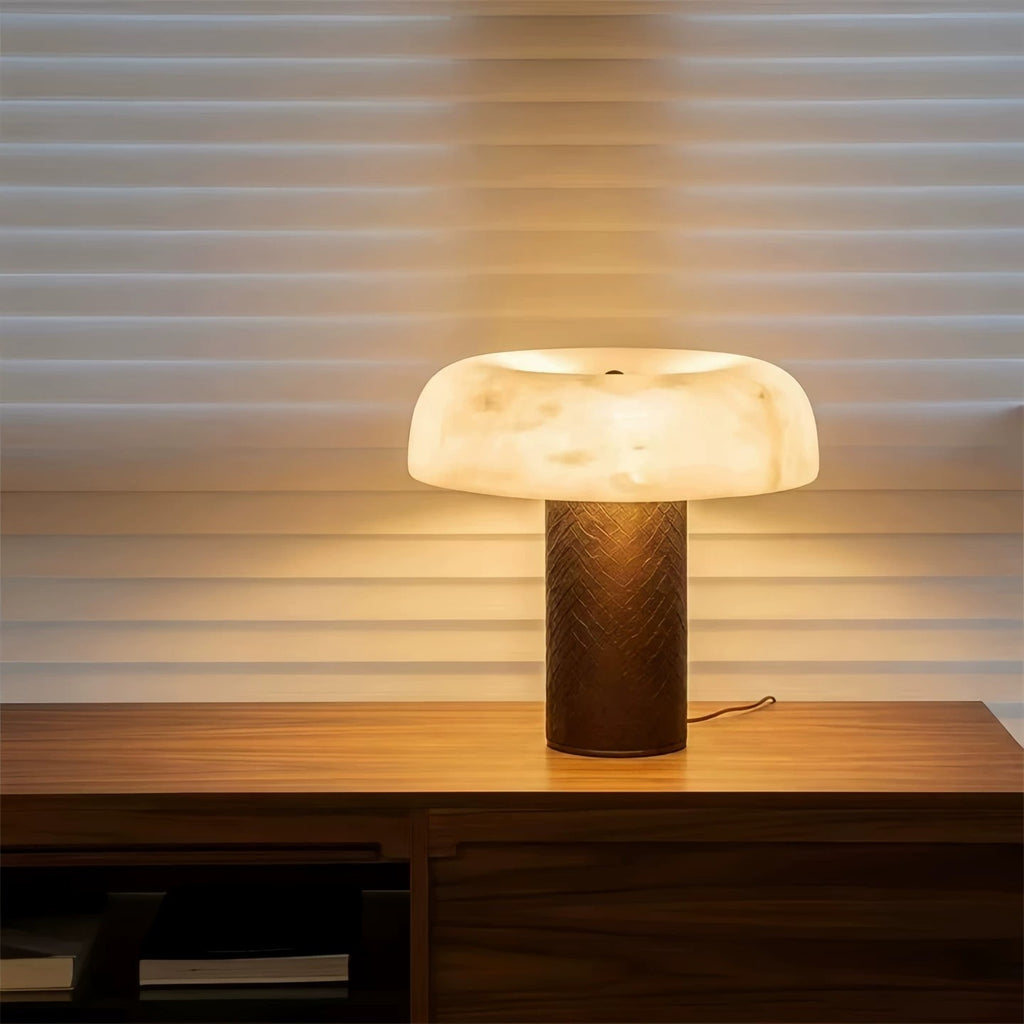 Warm glowing faux marble dome lamp with dark textured column base
