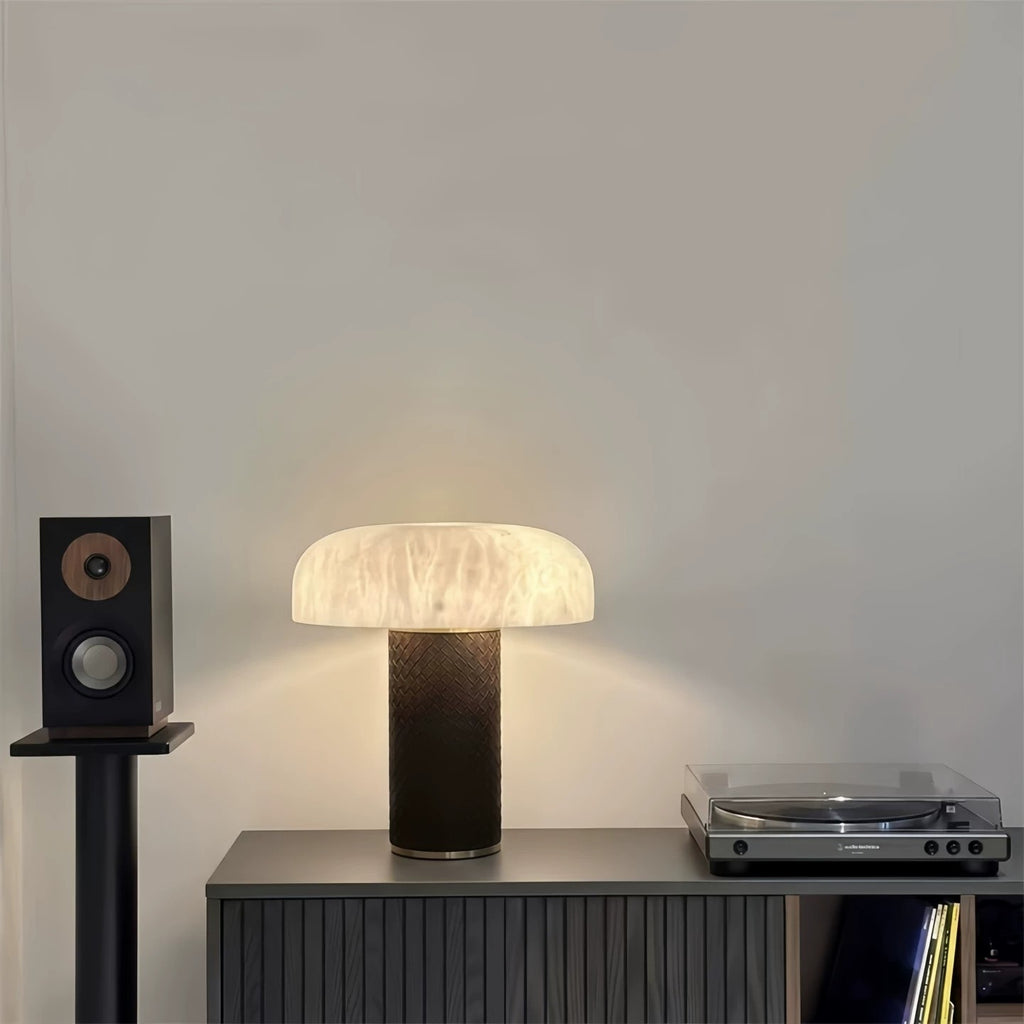 Postmodern faux marble dome lamp beside audio equipment on a modern cabinet