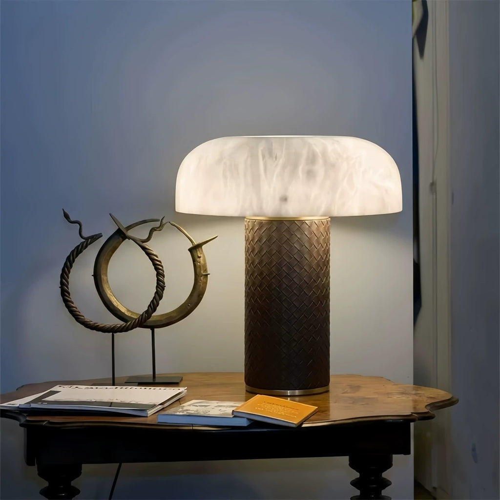 Faux alabaster mushroom style table lamp on a dark study desk