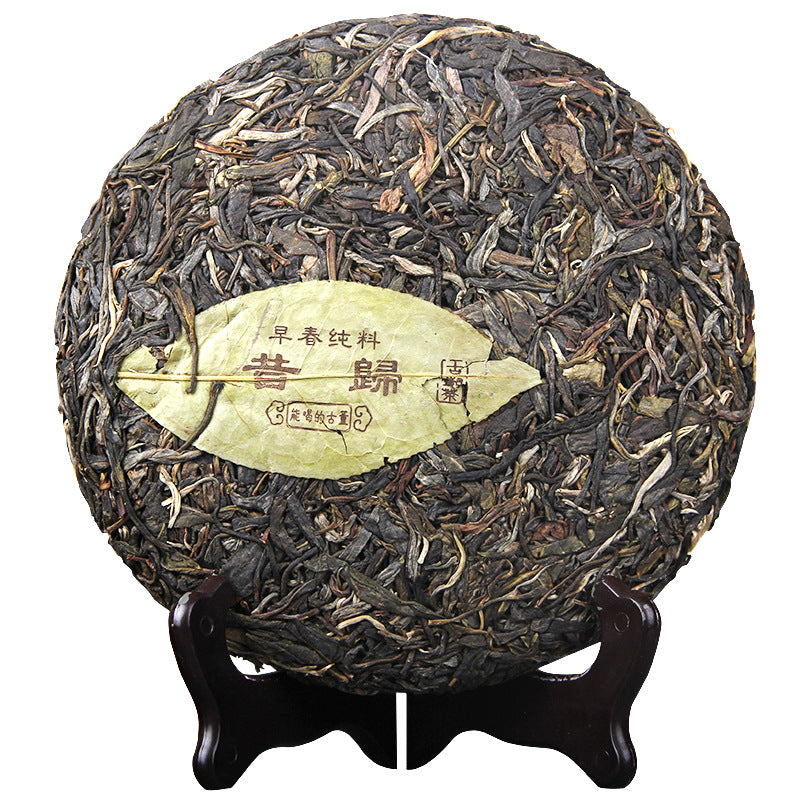 Unwrapped Xigui early-spring raw Pu-erh tea cake 357g with visible whole-leaf material 昔归