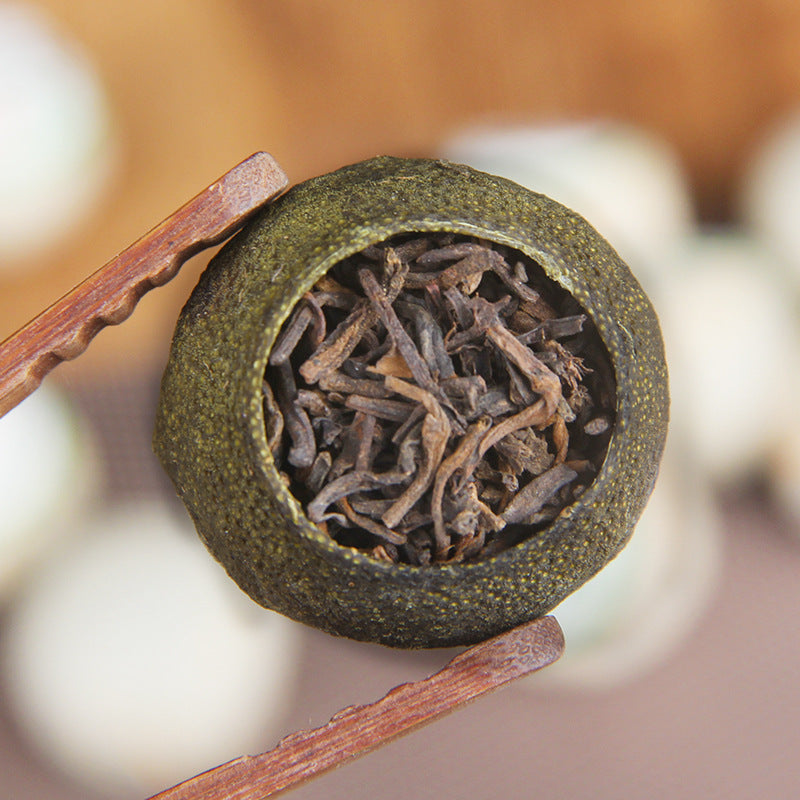 Opened Xinhui green mandarin filled with Gongting ripe Pu-erh tea leaves