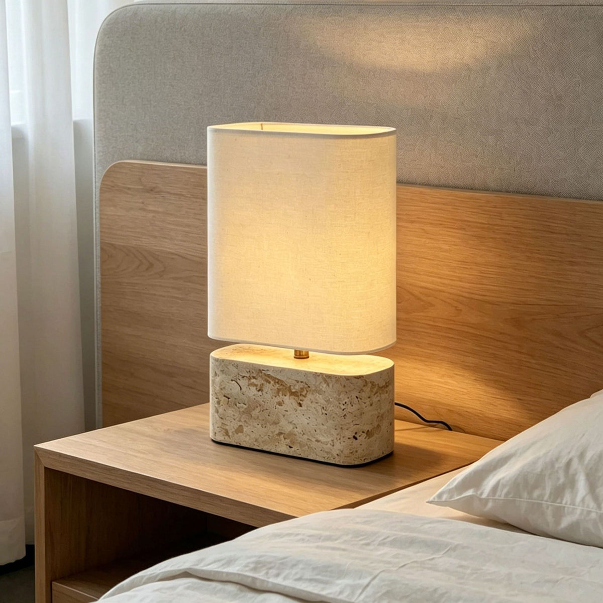 Compact yellow travertine oval table lamp with ivory fabric shade